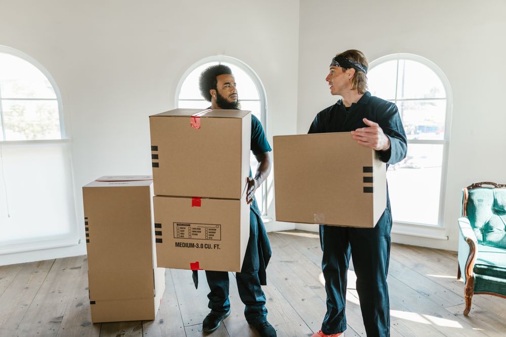 Movers carrying boxes during a full-service home move
