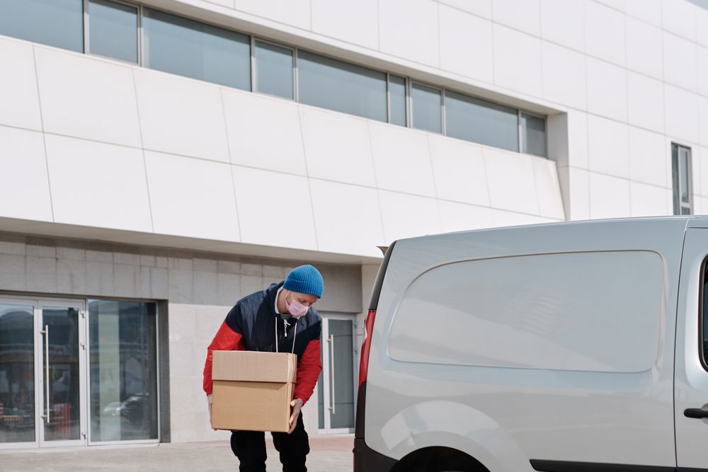 Movers loading a van outside an office building
